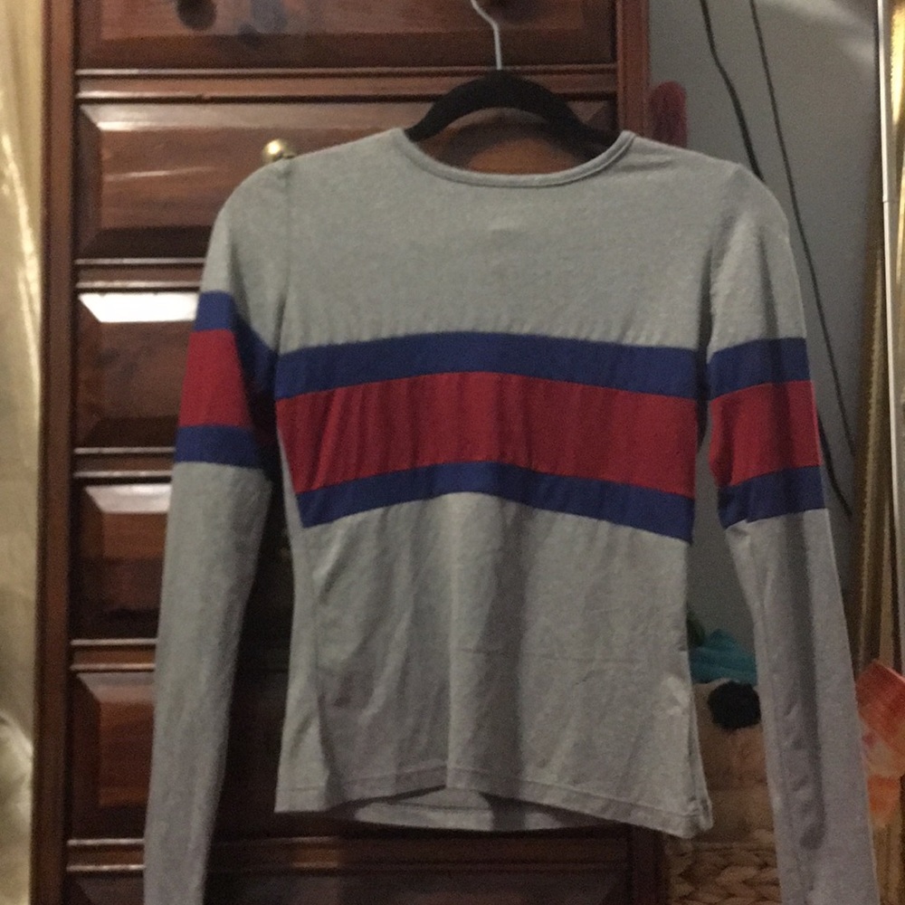 A grey long sleeve with blue and red.